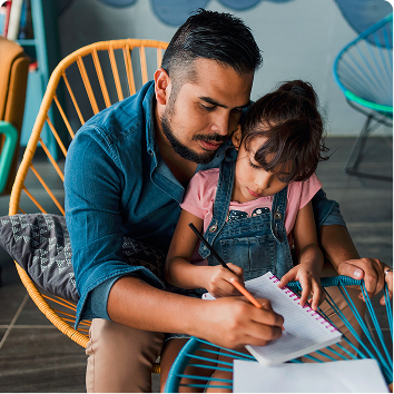 man helping child write